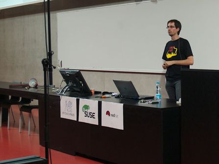 Adam Hořčica přednáší o protokolech pro IoT (a za chvíli rozsvítí lampu ležící vlevo)